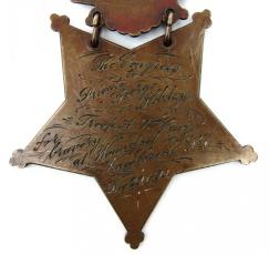Inscription on the reverse side of Private Hobday's Medal of Honor. The Congress to Private George Hobday, Troop A, 7th Cav'y for bravery at Wounded Knee Creek, S. D. Dec. 29 1890.